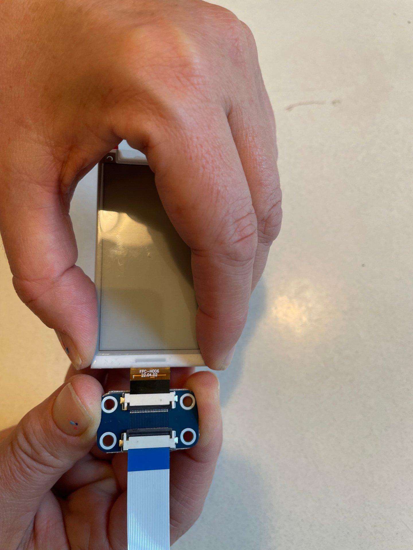 The badge ribbon inserted straight into the programmer connector