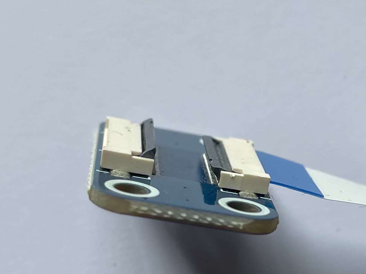 The programmer board with a ribbon connector latch flipped open
