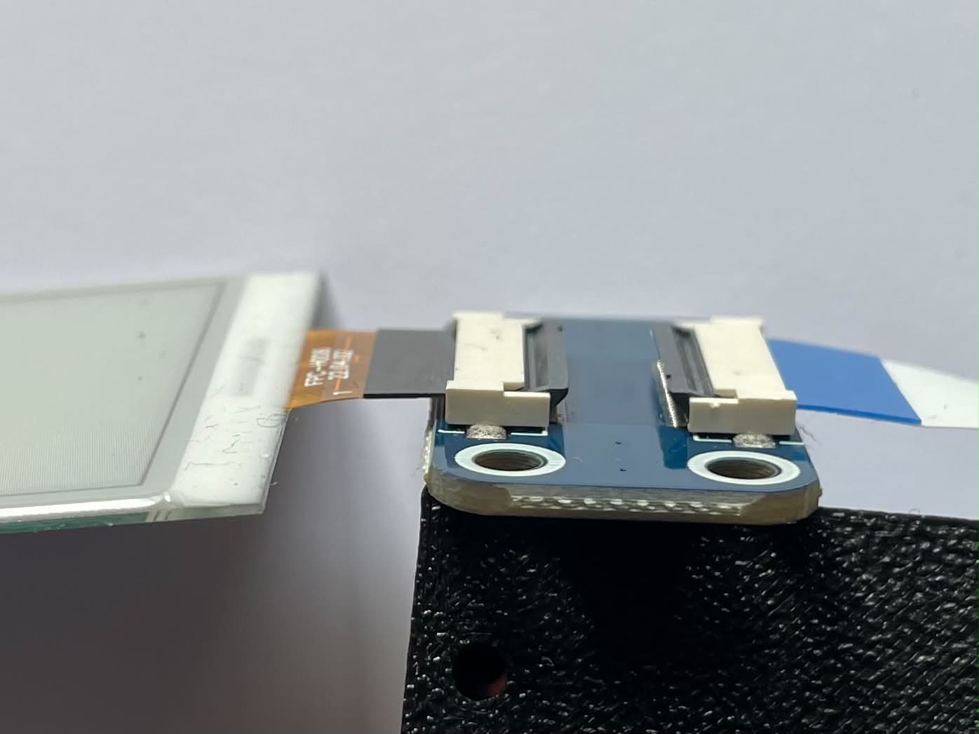 Side view of the programmer board with both ribbon connector latches closed flat